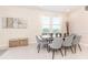 Bright dining area featuring a glass-top table and gray chairs at 7705 Fairfax Dr, Kissimmee, FL 34747