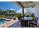 Outdoor patio with seating, dining area, and pool access at 7705 Fairfax Dr, Kissimmee, FL 34747