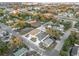 An aerial view of quaint neighborhood homes with mature trees and a glimpse of the city skyline in the background at 833 Texas Ave, Lakeland, FL 33815