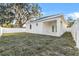 Exterior showing a spacious backyard with a covered patio and white fencing at 833 Texas Ave, Lakeland, FL 33815