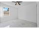 Bright bedroom featuring a ceiling fan, white walls, and marble-style tile flooring at 833 Texas Ave, Lakeland, FL 33815