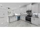 Modern open kitchen with white cabinetry, marble countertops, and stainless steel appliances at 833 Texas Ave, Lakeland, FL 33815