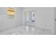 Bright living room with white walls, double doors, and marble-style tile flooring at 833 Texas Ave, Lakeland, FL 33815