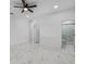 Spacious main bedroom featuring a modern ceiling fan, white walls, and ensuite bathroom at 833 Texas Ave, Lakeland, FL 33815