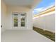 Covered patio featuring double doors and a view of the fenced backyard at 833 Texas Ave, Lakeland, FL 33815