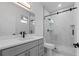 Modern bathroom featuring a gray vanity with marble countertops and a shower with glass doors at 835 Texas Ave, Lakeland, FL 33815