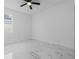 Neutral bedroom featuring ceiling fan, white walls, bright window, and marble tile flooring at 835 Texas Ave, Lakeland, FL 33815