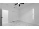 Neutral bedroom featuring ceiling fan, closet, white walls, and marble tile flooring at 835 Texas Ave, Lakeland, FL 33815