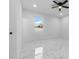 Bedroom featuring ceiling fan, bright window, white walls, and marble tile flooring at 835 Texas Ave, Lakeland, FL 33815