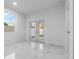 Bright, modern bedroom with marble floors and access to an outdoor patio at 835 Texas Ave, Lakeland, FL 33815