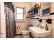 Updated bathroom features decorative shower curtain and black and white mosaic tile floor at 922 Se 13Th St, Ocala, FL 34471