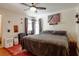 Comfortable bedroom featuring a ceiling fan and a cozy aesthetic with unique decorative elements at 922 Se 13Th St, Ocala, FL 34471