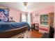 Charming bedroom with pink walls, hardwood floors and a large window for natural light at 922 Se 13Th St, Ocala, FL 34471