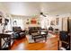 Cozy living room with hardwood floors, a ceiling fan, comfortable seating and vintage decor at 922 Se 13Th St, Ocala, FL 34471