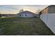 A view of the backyard with privacy fence and view of the lake at 1907 Eliza Ann St, Kissimmee, FL 34758