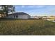 The backyard has a large grass area with a view of the lake at 1907 Eliza Ann St, Kissimmee, FL 34758