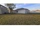View of the spacious backyard and rear house facade at 1907 Eliza Ann St, Kissimmee, FL 34758