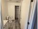 Bathroom features a toilet, sink, closet and gray plank flooring at 1907 Eliza Ann St, Kissimmee, FL 34758