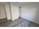 Bedroom features a closet and gray plank flooring at 1907 Eliza Ann St, Kissimmee, FL 34758