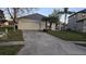 Charming single-story home with attached two car garage and long driveway at 1907 Eliza Ann St, Kissimmee, FL 34758