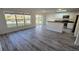 Open floor plan with a kitchenette overlooking the backyard pond through large windows at 1907 Eliza Ann St, Kissimmee, FL 34758