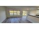 Open floor plan with a kitchenette overlooking a backyard pond view through large windows at 1907 Eliza Ann St, Kissimmee, FL 34758