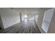 Living Room features three windows and gray plank flooring at 1907 Eliza Ann St, Kissimmee, FL 34758