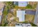 Scenic aerial view showing the property's location among lush trees, with a clear view of the home's layout at 1220 George St, Winter Springs, FL 32708