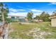 Large, fenced backyard with a mix of grass, trees, and garden features, ideal for relaxation and recreation at 1220 George St, Winter Springs, FL 32708