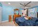 Second view of the bedroom showcasing wood furniture, ceiling fan, and ensuite bathroom at 1220 George St, Winter Springs, FL 32708