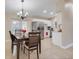 Cozy dining area featuring a wooden table, chandelier lighting, and easy access to the kitchen at 1220 George St, Winter Springs, FL 32708