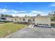 Inviting yellow single-story home features a ramp, tidy landscaping and an RV parked in the background at 1220 George St, Winter Springs, FL 32708