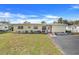 Charming yellow single-story home with a well-maintained lawn and accessible ramp leading to the front door at 1220 George St, Winter Springs, FL 32708