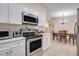 Well-lit kitchen featuring stainless steel appliances, white cabinetry, and an open view to the dining area at 1220 George St, Winter Springs, FL 32708