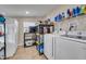 Bright laundry room with tile flooring and modern appliances offers convenience and ample storage options at 1220 George St, Winter Springs, FL 32708