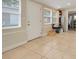 Mud room featuring neutral paint, neutral tile floors, and a view to the rest of the home at 1220 George St, Winter Springs, FL 32708