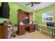 Office space featuring green paint, neutral tile floors, a ceiling fan, and a large desk at 1220 George St, Winter Springs, FL 32708