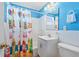 Bright bathroom with tile accents and a fun surfboard-themed shower curtain at 38 Seaside Dr, Ormond Beach, FL 32176