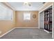 Bedroom featuring neutral walls, carpet flooring, closet system, and natural light from a large window at 38 Seaside Dr, Ormond Beach, FL 32176