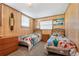 Bedroom featuring two twin beds with colorful comforters and paneled walls at 38 Seaside Dr, Ormond Beach, FL 32176