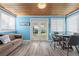 Bright dining area with wooden ceiling, wood floors, and a view of the back yard at 38 Seaside Dr, Ormond Beach, FL 32176