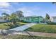 Charming single-story green home with a well-manicured lawn and a concrete driveway leading to the entrance at 38 Seaside Dr, Ormond Beach, FL 32176