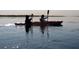 Kayakers enjoying a day on the lake with calm waters and reflections in the surface at 38 Seaside Dr, Ormond Beach, FL 32176