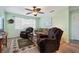 Spacious living room with two armchairs, a sofa, a ceiling fan, and a decorative rug at 38 Seaside Dr, Ormond Beach, FL 32176