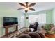 Cozy living room with neutral walls, a ceiling fan, a comfortable seating arrangement, and a window at 38 Seaside Dr, Ormond Beach, FL 32176