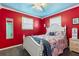 Main bedroom with large windows, marine decor, and comfortable nautical-themed bedding at 38 Seaside Dr, Ormond Beach, FL 32176