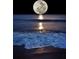 Beautiful full moon shining over gentle waves, creating a serene and magical night scene at 38 Seaside Dr, Ormond Beach, FL 32176