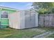 Backyard storage shed made of vinyl siding, wood fencing and concrete paver path at 38 Seaside Dr, Ormond Beach, FL 32176