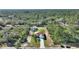 The long driveway leads up to the home and detached shed on a beautifully landscaped, treed lot at 4101 Poinciana Dr, Indian Lake Estates, FL 33855