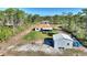 Wide angle aerial view of a home and oversized shed and manicured grounds at 4101 Poinciana Dr, Indian Lake Estates, FL 33855